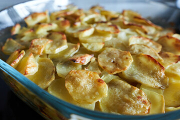 Baked potatoes in a baking dish, close-up, selective focus