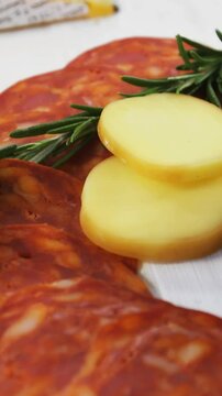 Slices of ham with cheese, green olives and herbs