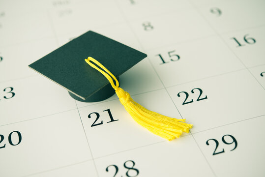 Graduation cap or mortarboard on white blank calendar background. University graduation ceremonies on commencement day schedule. Education, learning successful for future concept.