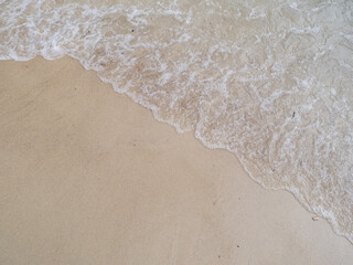 background of waves and foam on beach sand. summer vacation concept