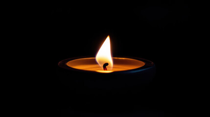 Fototapeta premium close up of flickering flame illuminating dark background, creating warm and tranquil atmosphere. soft glow of candlelight evokes sense of calm and serenity