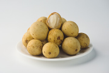 Fresh Tropical Langsat Fruits Arranged on a White Plate Highlighting Their Juicy Interior