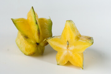 Fototapeta premium Close-Up of Ripe Yellow Starfruit on a White Background