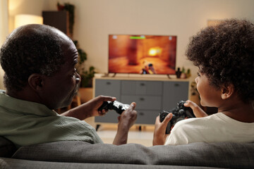 Elderly Black Man Playing Video Games with Child