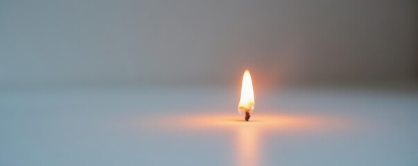 Fototapeta premium Tiny flame flickering on a plain white surface, simple, flicker, hot