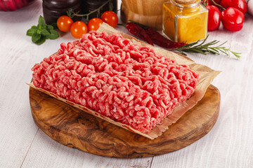 Raw minced beef meat over board