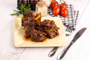 Prepared tasty beef ribs with sauce