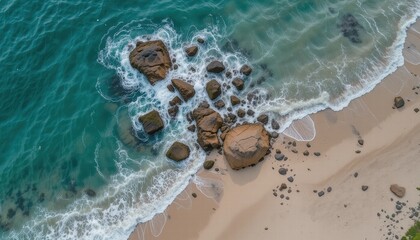 Obraz premium Photo from above of sea water crashing against a rocky cliff on the seashore