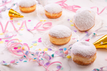 Berliner, carnival, donuts with paper streamers and confetti for carnival, holiday concept