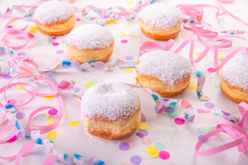 Berliner, carnival, donuts with paper streamers and confetti for carnival, holiday concept
