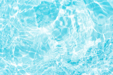 Blue water with ripples on the surface. Defocus blurred transparent blue colored clear calm water surface texture with splashes and bubbles. Water waves with shining pattern texture background.