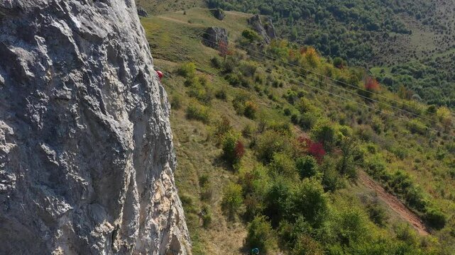Aerial view of mountain rescuer doing rescue operations hanging on a rope