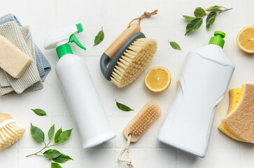 Eco friendly cleaning products and lemon on white surface promoting sustainability