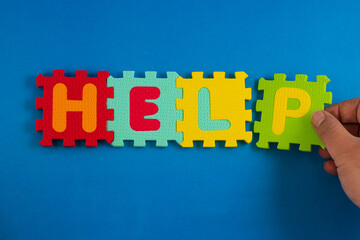 A close-up of foam puzzle pieces spelling out the word 