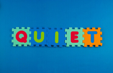 A close-up of foam puzzle pieces spelling out the word 