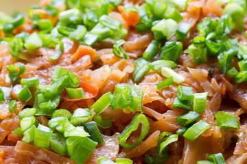 Close-up of stewed cabbage with onions. Stewed cabbage with fresh green onions.