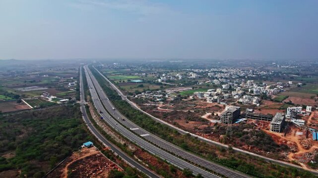nehru outer ring road, residential buildings with blue sky hyderabad, telangana. day time semi orbit drone shot.