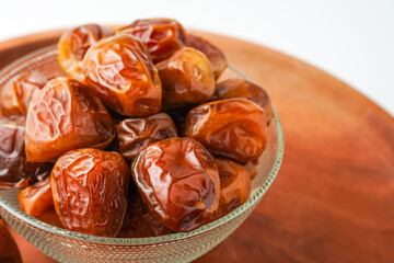Dates fruit sukari or kurma sukari, in bowl isolated on white background