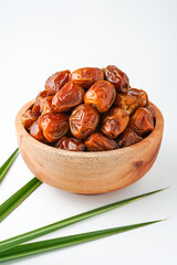 Dates fruit sukari or kurma sukari, in wooden bowl isolated on white background