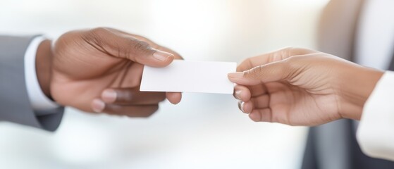 Obraz premium A professional exchange of a blank business card between two individuals, symbolizing networking and business connections in a corporate environment.