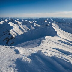 A series of snow-covered ridges, the deep blue sky contrasting with the white snow.