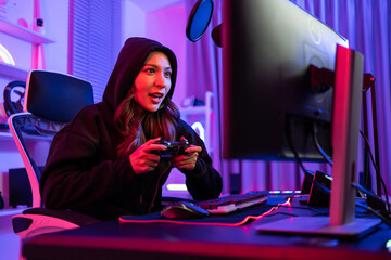Asian beautiful esport woman gamer play online video game on computer.  © Kawee