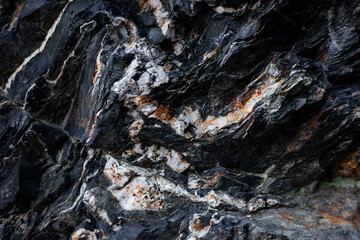 Close up of rugged rock surface with dark and light striations