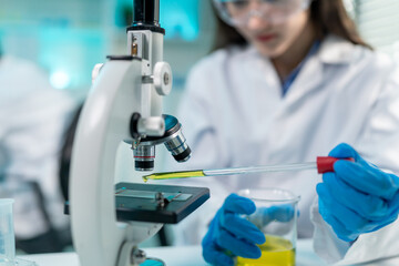 Asian female scientist working in biotechnology research laboratory. 