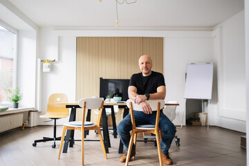 Fototapeta premium Entrepreneur sitting in modern workspace