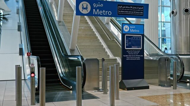 Empty stairs and elevators leading to Dubai Metro at Dubai International Airport. Sleek, modern design highlights efficient infrastructure and urban connectivity.
