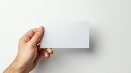 Obraz premium Male Hand Holding Blank White Card Against White Background