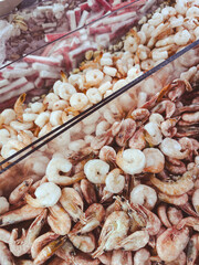 A pile of shrimp and other seafood in a container
