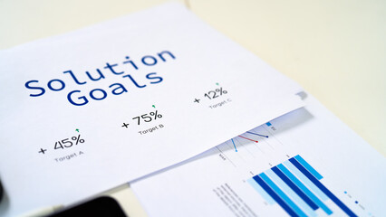 A collection of documents displaying "Solution Goals" with various statistics and charts illustrating performance metrics.