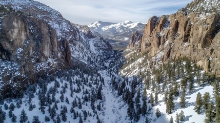 Snowy mountain landscape, serene winter scene with towering cliffs and frozen river, perfect for nature inspiration.