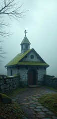 Fototapeta premium Weathered stone walls and a moss-covered roof conceal a small medieval church hidden in the fog, secret, medieval