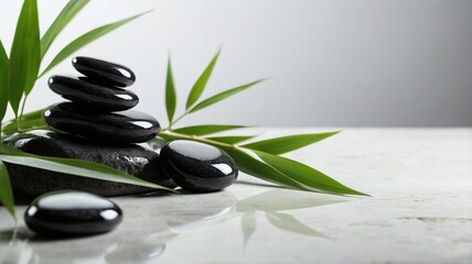 Black zen spa stones with banmoo leaves on white backgruond