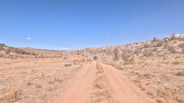 Recreation road mountain desert valley following UTV Uta. Off road trail riding in 4x4 all terrain vehicle for sport and recreation. Desert landscape, dusty trails and recreation areas. Southwest Utah