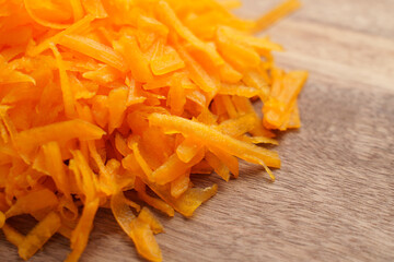 Grated shredded fresh organic pumpkin on a rustic board. Butternut squash. Macro shot. Healthy ingredients 