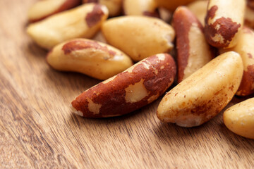 Raw Brazil nuts on brown kitchen board. Macro shot. 