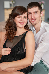 Mother's Day Greeting Card. Happy family, pregnant woman with  flowers. Motherhood, pregnancy, happiness concept,  married couple expecting a baby