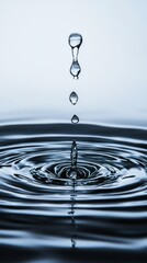 Water droplets fall gracefully, creating concentric circles in a tranquil pool. The calming blue hues enhance the beauty of this serene moment at dusk