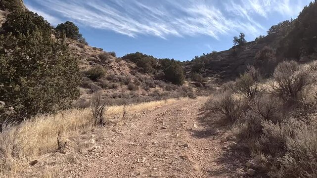 Recreation road mountain dirt desert Utah POV. Off road trail riding in 4x4 all terrain vehicle for sport and recreation. Desert landscape, dusty trails and recreation areas. Southwest Utah