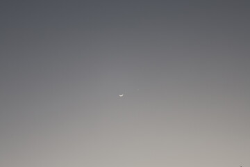 New moon on early evening sky