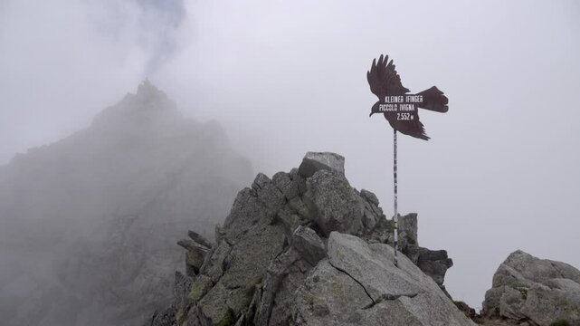 Mount Little Ifinger with fog drifting across Mount Ifinger in the background on an overcast day.