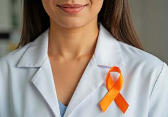 Woman doctor with orange ribbon for Leukemia, Kidney cancer day, world Multiple Sclerosis, CRPS, Self Injury Awareness, closeup