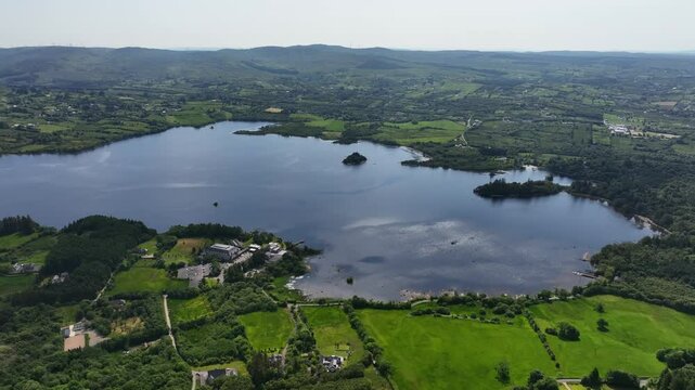 Lough Eske, County Donegal, Ireland, June 2023. Drone captures a panoramic aerial view of the lake, with wind ripples moving across the surface on a bright sunny day.