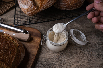Freshly Baked Rustic Artisan Sourdough Bread on Wooden Table.