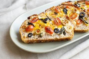 open sandwiches sourdough bread toast for breakfast or brunch with cheese tomato olives.