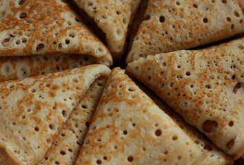 baked pancakes openwork in a hole triangles close-up