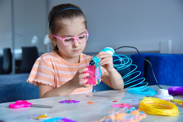 Girl plays with  3D pen.